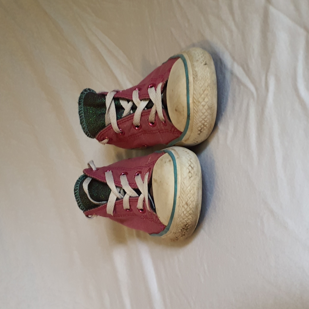Pink, blue, and black low top Converse